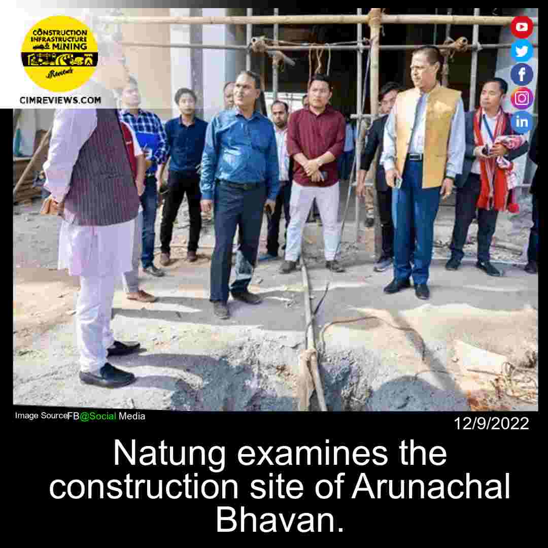 Natung examines the construction site of Arunachal Bhavan.